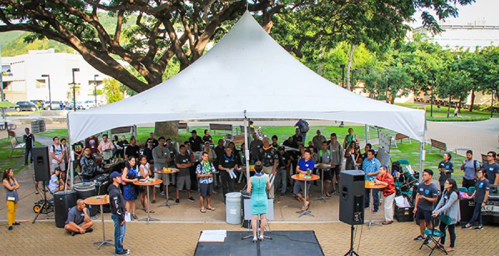 Image of audience in campus courtyard attending a pitch competition